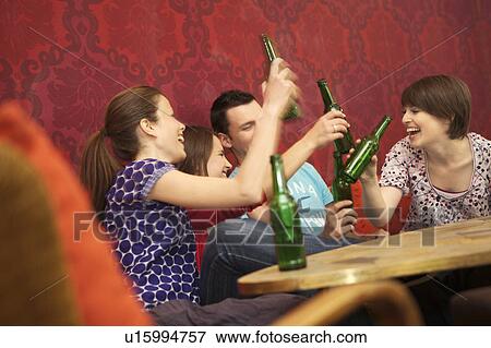 Stock Photo - Friends in a bar / restaurant. Fotosearch