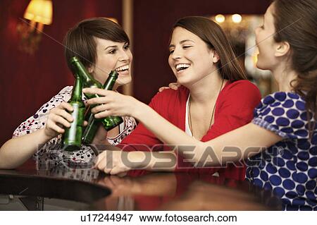 Friends in a bar / restaurant View Large Photo Image Stock Photo - Friends in a bar / restaurant. Fotosearch