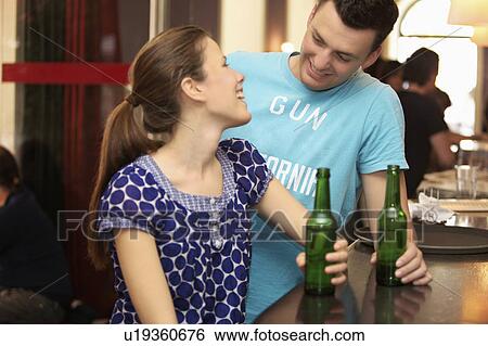 Friends in a bar / restaurant View Large Photo Image Stock Photograph - Friends in a bar / restaurant. Fotosearch