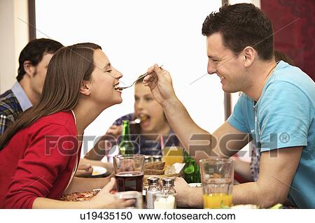 Stock Image - Friends in restaurant. Fotosearch