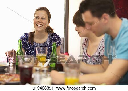 Stock Image - Friends in restaurant. Fotosearch