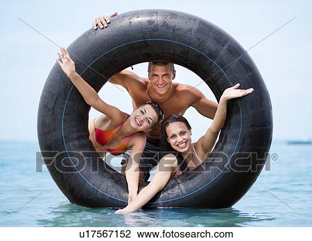 Stock Image - Friends playing in the water. Fotosearch