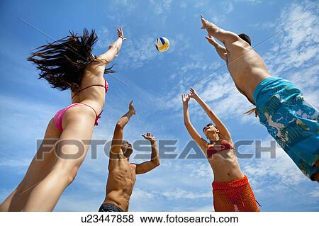 Friends playing volleyball at the beach View Large Photo Image Stock Photo - Friends playing volleyball at the beach. Fotosearch