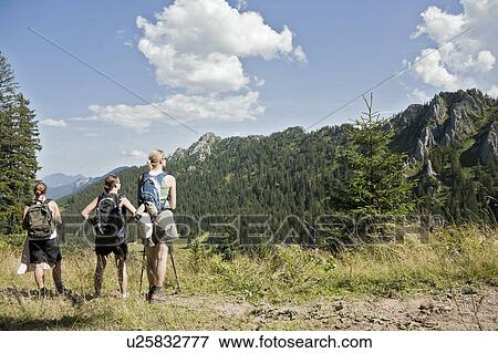 Stock Photo - Friends resting after a long hike. Fotosearch