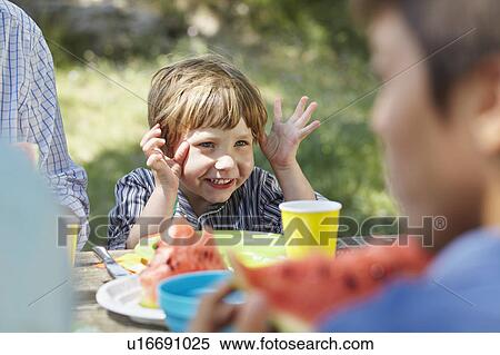 Stock Photography - Gesticulating little boy at picnic. Fotosearch