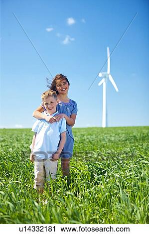 Girl and boy at wind turbine View Large Photo Image Stock Image - Girl and boy at wind turbine. Fotosearch