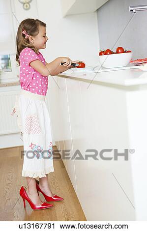 Girl cutting tomatoes in high heels View Large Photo Image Stock Image - Girl cutting tomatoes in high heels. Fotosearch
