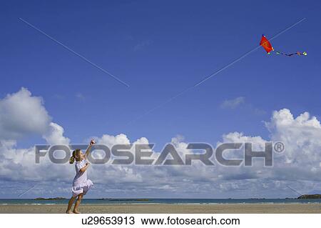 Girl flying a kite View Large Photo Image Stock Image - Girl flying a kite. Fotosearch