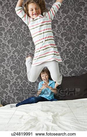 Girl jumping in bed View Large Photo Image Stock Image - Girl jumping in bed. Fotosearch