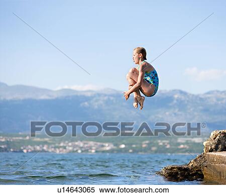 Girl jumping into water View Large Photo Image Stock Photography - Girl jumping into water. Fotosearch