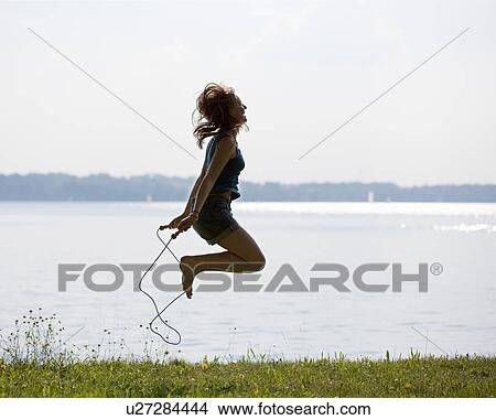 Picture - Girl jumping with rope. Fotosearch