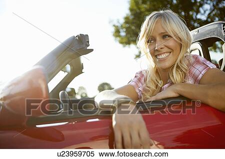 Girl leaning out of her electric car View Large Photo Image Stock Photography - Girl leaning out of her electric car. Fotosearch