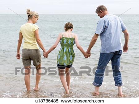 Girl on beach with grandparents View Large Photo Image Stock Photography - Girl on beach with grandparents. Fotosearch