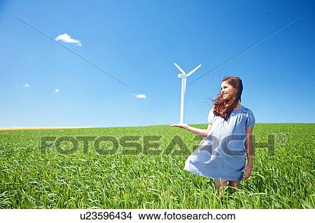 Girl on field with wind turbine View Large Photo Image Picture - Girl on field with wind turbine. Fotosearch