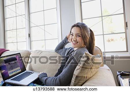 Girl on laptop at home View Large Photo Image Stock Photo - Girl on laptop at home. Fotosearch