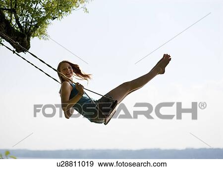 Stock Photo - Girl on swing. Fotosearch