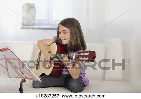 Girl playing the guitar View Large Photo Image Stock Photo - Girl playing the guitar. Fotosearch