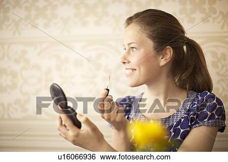 Girl putting make up on View Large Photo Image Stock Photograph - Girl putting make up on. Fotosearch