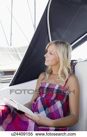 Girl reading on boat View Large Photo Image Stock Photography - Girl reading on boat. Fotosearch