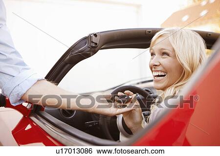 Girl receiving keys to an electric car View Large Photo Image Stock Photograph - Girl receiving keys to an electric car. Fotosearch