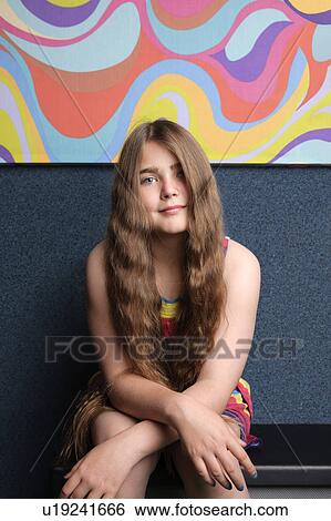 Girl sitting in front of funky painting View Large Photo Image Stock Photograph - Girl sitting in front of funky painting. Fotosearch