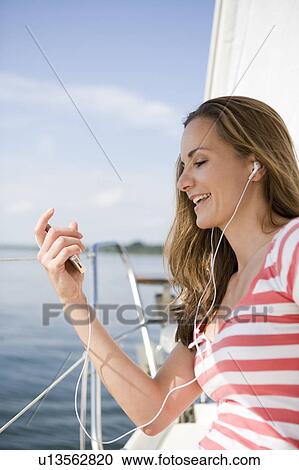 Girl sitting on boat View Large Photo Image Stock Image - Girl sitting on boat. Fotosearch