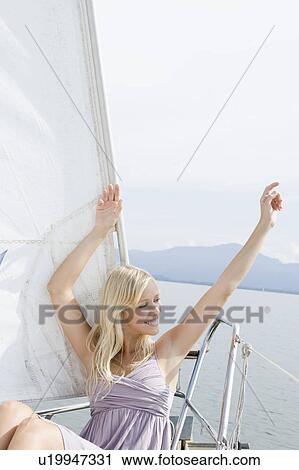 Girl sitting on boat View Large Photo Image Stock Image - Girl sitting on boat. Fotosearch