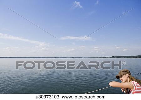Stock Image - Girl sitting on boat. Fotosearch