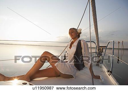 Girl sitting on boat View Large Photo Image Stock Photo - Girl sitting on boat. Fotosearch