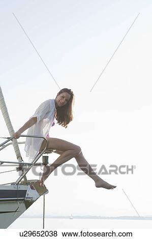 Girl sitting on front of boat View Large Photo Image Stock Photo - Girl sitting on front of boat. Fotosearch