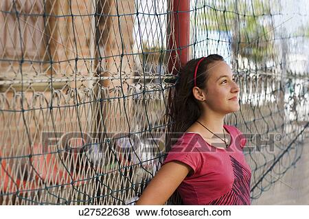 Stock Photo - Girl smiling looking off the distance. Fotosearch