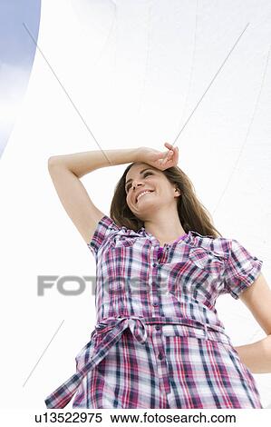 Stock Photography - Girl standing in front of sail. Fotosearch