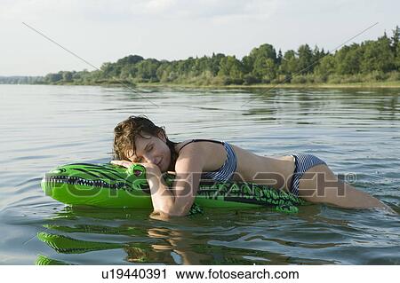 Girl standing on front of boat View Large Photo Image Stock Image - Girl standing on front of boat. Fotosearch
