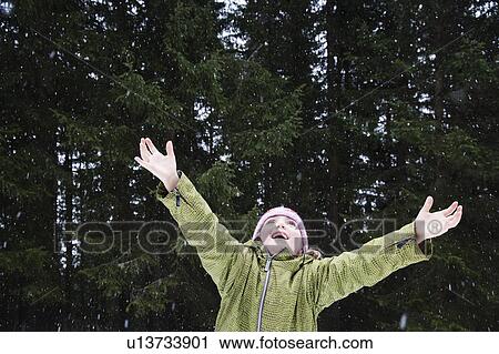 Girl trying to catch snowflakes View Large Photo Image Stock Image - Girl trying to catch snowflakes. Fotosearch