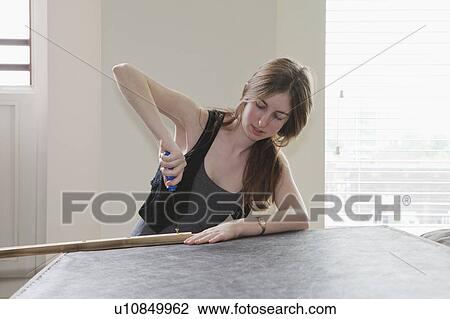 Girl using screwdriver View Large Photo Image Stock Image - Girl using screwdriver. Fotosearch