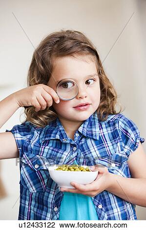 Girl watching peas with a magnifier View Large Photo Image Stock Image - Girl watching peas with a magnifier. Fotosearch