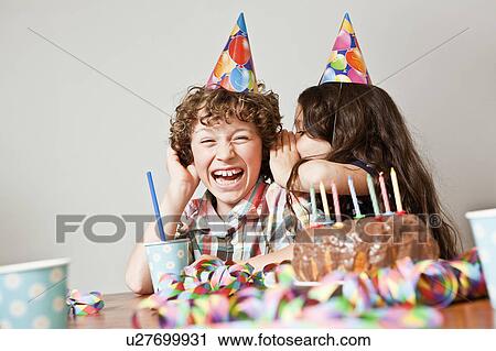 Girl whispers in boys ear at birthday View Large Photo Image Stock Image - Girl whispers in boys ear at birthday. Fotosearch