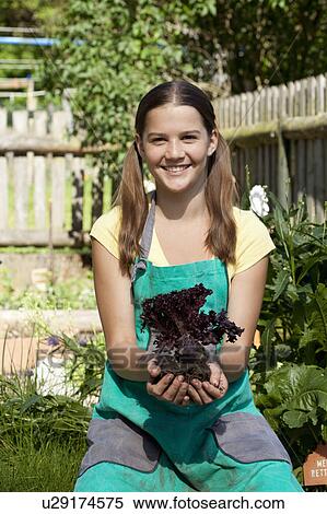 Stock Photography - Girl with salad in garden. Fotosearch
