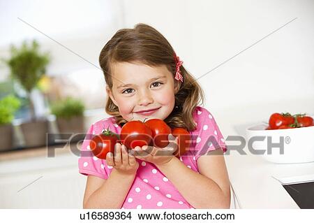 Girl with tomatoes View Large Photo Image Picture - Girl with tomatoes. Fotosearch