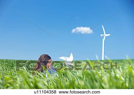 Girl with wind turbine View Large Photo Image Stock Photo - Girl with wind turbine. Fotosearch