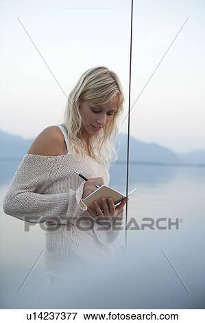 Girl writing in a book View Large Photo Image Stock Photo - Girl writing in a book. Fotosearch