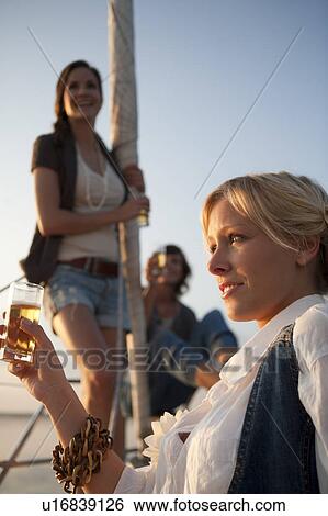 Girls drinking beer on boat View Large Photo Image Stock Photograph - Girls drinking beer on boat. Fotosearch