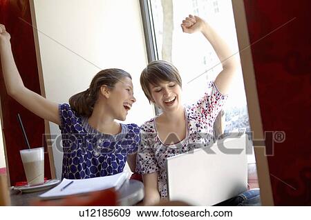 Stock Photo - Girls hanging out in a cafe. Fotosearch