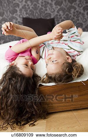 Girls hanging out in parents bed View Large Photo Image Stock Photo - Girls hanging out in parents bed. Fotosearch