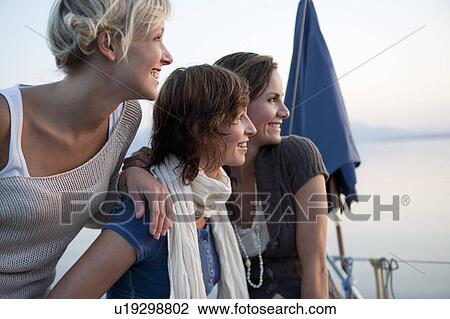 Stock Image - Girls on boat. Fotosearch