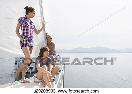 Girls relaxing on boat View Large Photo Image Stock Image - Girls relaxing on boat. Fotosearch