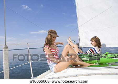 Girls relaxing on boat View Large Photo Image Stock Photo - Girls relaxing on boat. Fotosearch