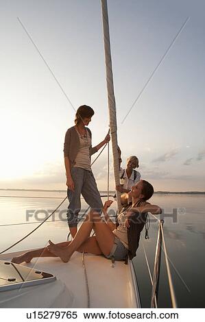 Stock Photography - Girls relaxing on boat. Fotosearch