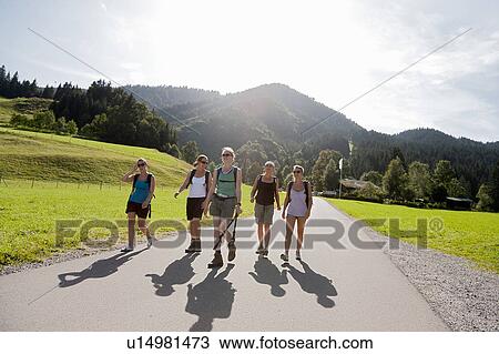 Stock Image - Girls returning from a long hike. Fotosearch
