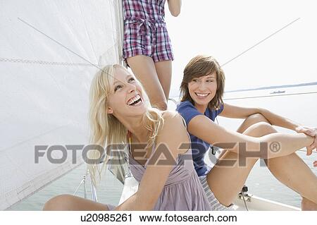 Girls sitting on boat View Large Photo Image Stock Image - Girls sitting on boat. Fotosearch